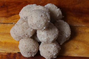 Close-up of coconut rava ladoos on wood background in india