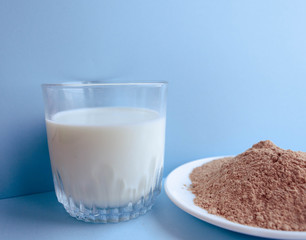 Natural organic Ingredients for making a cake, biscuit, pie, cookies, flour cacao  and milk on a blue background.  homemade  with copy space. Flat lay.
