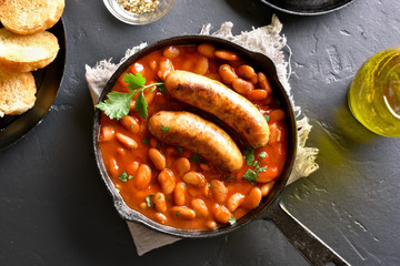 Sausages with baked white beans in tomato sauce