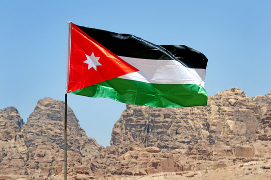 Jordan Flag And Tourist Visiting Petra Unesco Heritage Site 