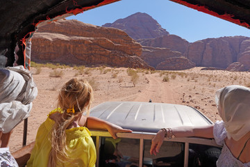 Jordan, The Wadi Rum Desert - tourist visiting the desert with 4x4 jeep car     taking pictures    ...