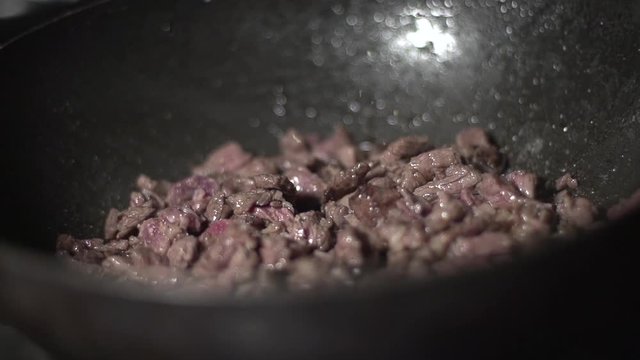 Skillfully cooking red meat in a pan