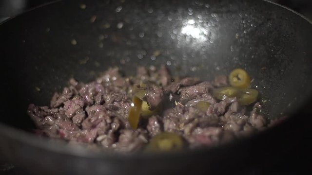Skillfully cooking red meat in a pan