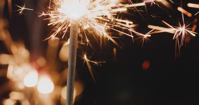 4k resolution of Firework sparkler burning in slowmotion, black background