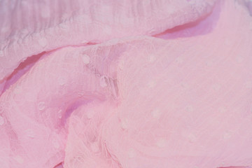 Obraz na płótnie Canvas crumpled and twisted delicate pink translucent polka dot scarf