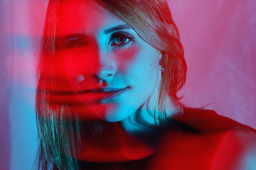 Weird two color light portrait of a young woman