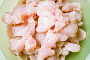 Small pieces of raw chicken in green eggplant for pickling.