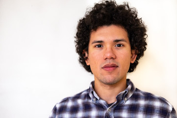 Latin american man looking happy on a white background 