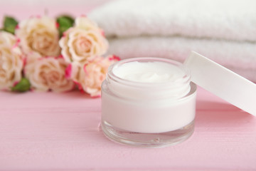 Fototapeta na wymiar skincare cream and flowers on the table. Cosmetics for skin care.