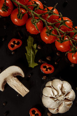 garlic, garlic on a black background with tomatoes and mushrooms