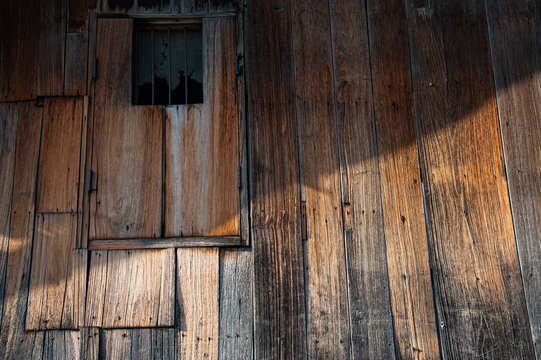 old wooden wall and window in ancient Thai house. Pattern background 