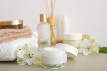 skincare cream and flowers on the table. Cosmetics for skin care.