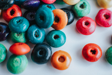 Fototapeta premium colorful wooden beads on a white table