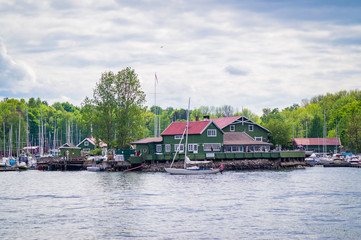 Obraz premium yacht passing a green house on the river