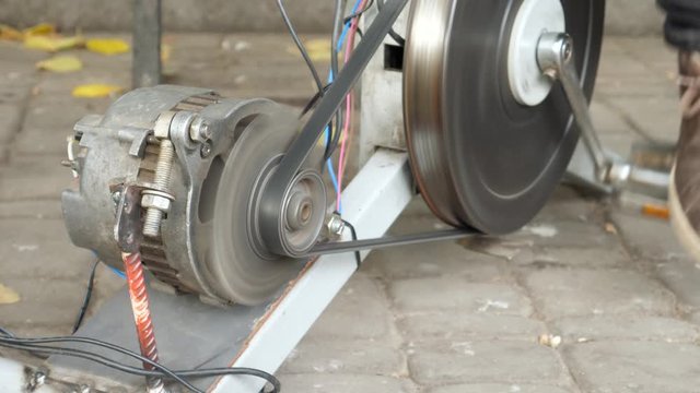 Pedaling bicycle and generating electrical energy. DIY technology. Working with electronic components. Dynamo electrical generator machine