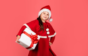 Christmas preparation. happy new year. merry christmas. xmas joy mood. small santa kid pink wall. little girl present box. winter holiday shopping. time for presents. gift brings joy and happiness