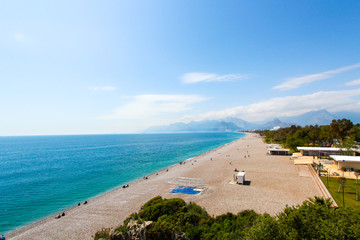 Fototapeta premium Tourist beach of the Mediterranean Sea. Antalya, Turkey, April 6, 2019.