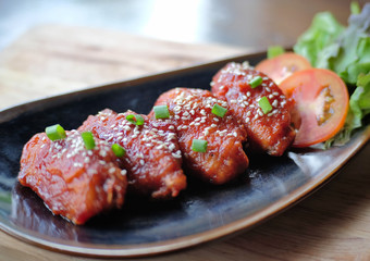 Chicken wings with sauce in ceramic plate