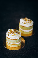 Cakes with white cream and on a black background. Baking and sweets.