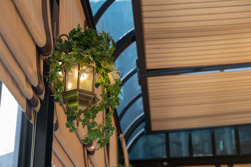 Lamps that are decorated with leaves In a comfortable seating restaurant atmosphere.