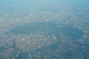 Aerial view of Bangkok, Thailand from airplane. Bird eyes view of the forest in middle of capital city.