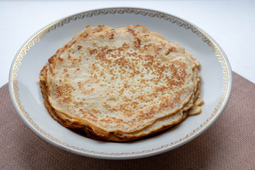 homemade russian pancake isolated on white background, close-up, top view