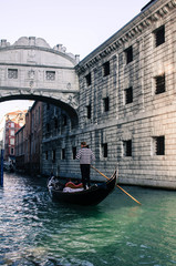 Fototapeta na wymiar A lonely gondolier in Venice