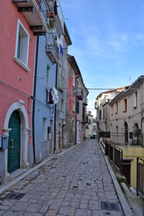 Fototapeta na wymiar Campobasso, Italy, 12/24/2019. A narrow street between the alleys and buildings of a medieval city