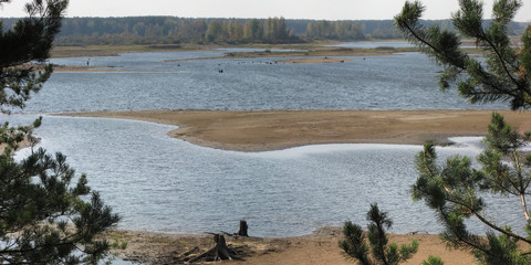 Fototapeta na wymiar Autumn pike fishing on the Rybinsk reservoir, beautiful panorama.