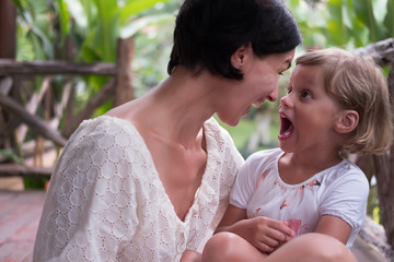 Fototapeta premium Mom and daughter emotional photo. Green background.