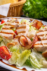 Caesar salad on dark wooden rustic background