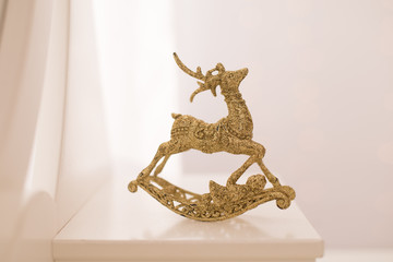 Beautiful golden reindeer toy isolated on white background, little Santa helper decoration, Christmas tree bauble