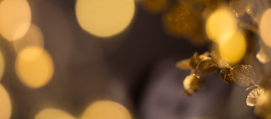 Christmas background gold branches decorations on the background of Christmas lights and candles