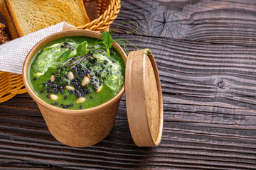 broccoli spinach cream soup on rustic wooden background