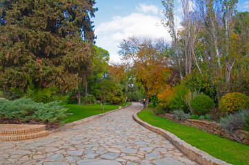 Brown stone pathway in natural park of roman city Italica, Seville, Spain