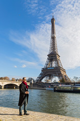 An adult man  travels through Paris