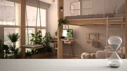 White table or shelf with crystal hourglass measuring the passing time over studio apartment with loft bunk double bed, mezzanine, architecture interior design, copy space background