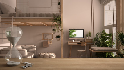 Wooden table, desk or shelf with crystal modern hourglass measuring passing time in a countdown to a deadline over studio apartment with loft bunk bed, mezzanine, interior design