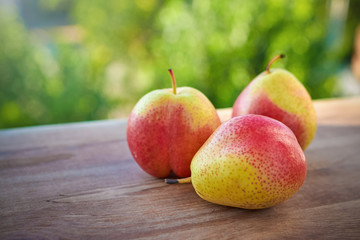 Pears on a windowsill on a background of blurred greens