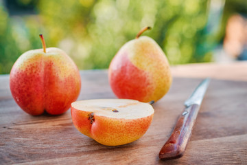Pears on a windowsill on a background of blurred greens