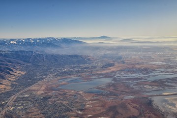 Fototapeta na wymiar Wasatch Front Rocky Mountain Range Aerial view from airplane in fall including urban cities and the Great Salt Lake around Salt Lake City, Utah, United States of America. USA.