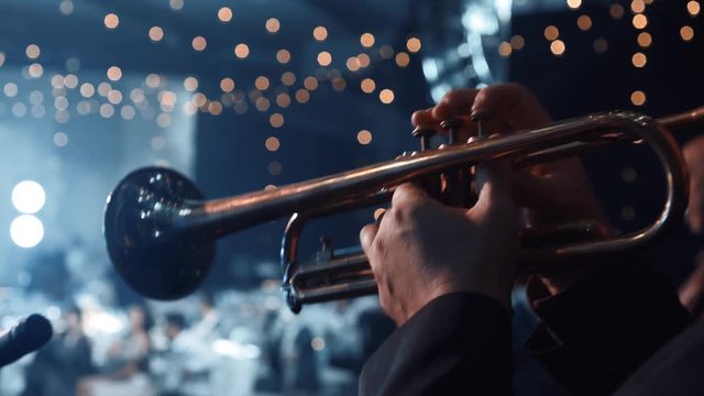 Trumpet player. Trumpeter hands playing brass music instrument close up. Detail of the player's fingers on trumpet. Close up of trumpet players fingers working the vavles