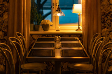 A clean table setting waiting for guests in a modern vintage restaurant