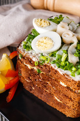a huge herring sandwich with mayonnaise and quail eggs
