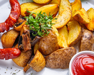 baked potatoes with sausages on a wooden rustic background