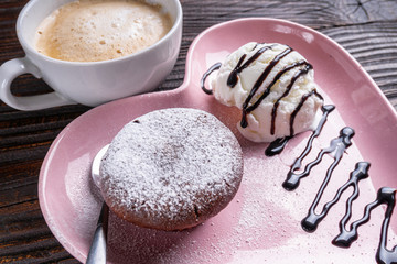 chocolate fondant with ice cream on wooden rustic background