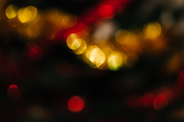 Bokeh of New Year and Christmas lights and decor. Colorful Christmas abstract background. Blurred...