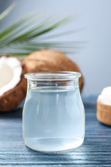Coconut oil on blue wooden table, closeup view