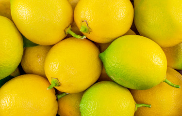 Fresh yellow - green lemons close-up. Food backgrounds.