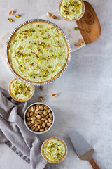 Flat lay arrangement of pistachio cheesecakes.